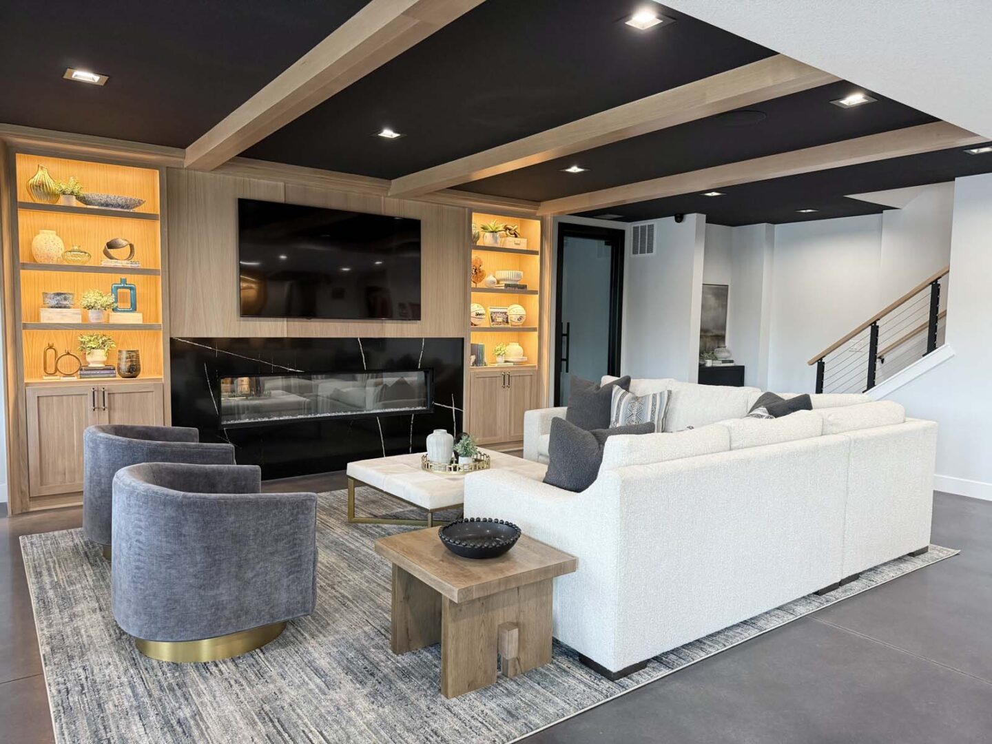 Modern living room with built-in shelves, fireplace, and comfortable seating.
