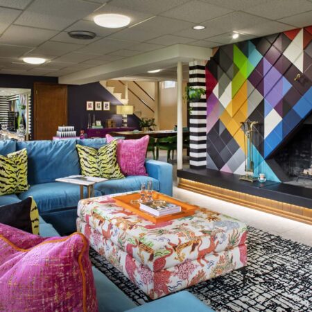 Colorful modern living room with bold geometric wall art and eclectic furniture.