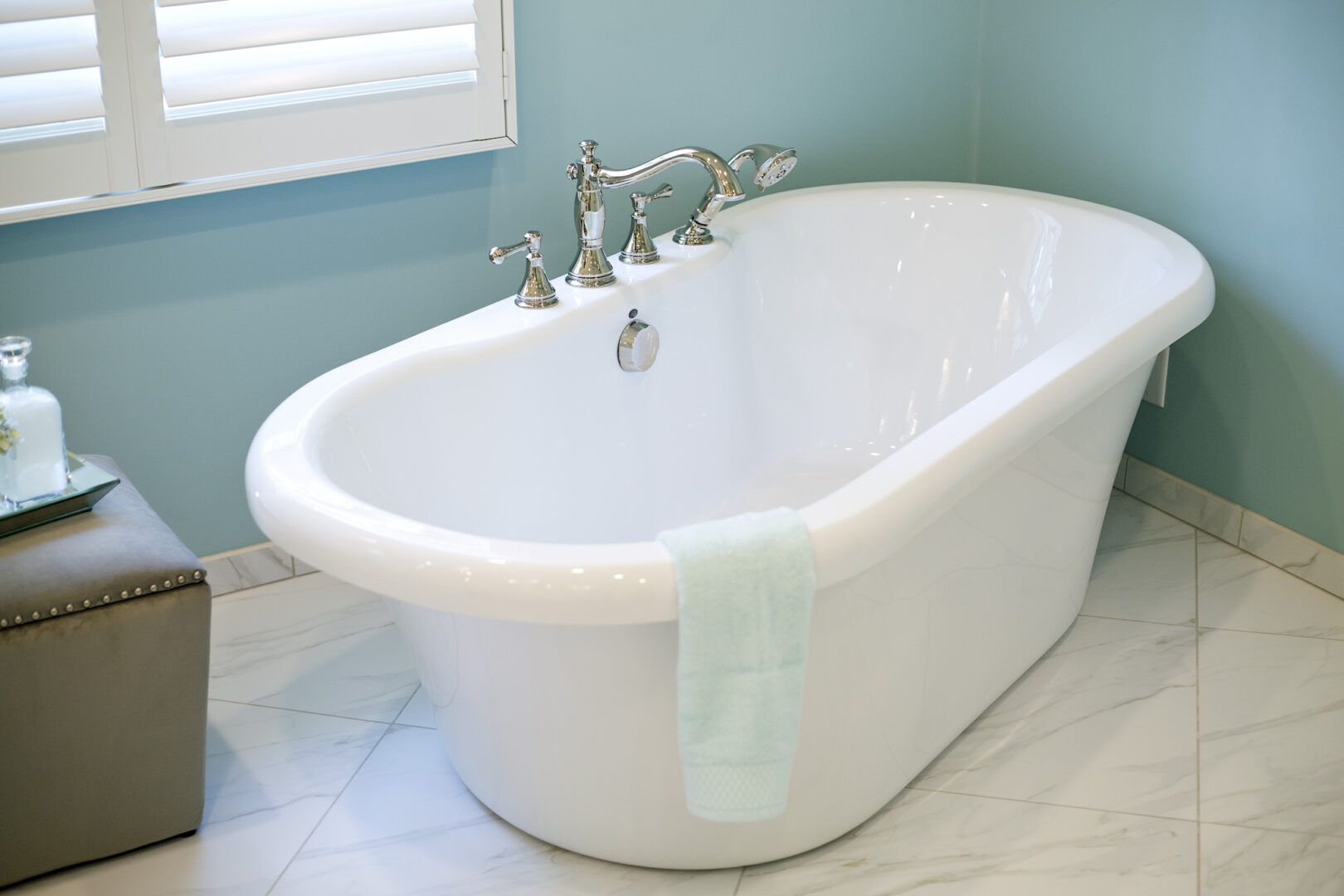 Elegant freestanding bathtub with chrome fixtures in a modern bathroom.