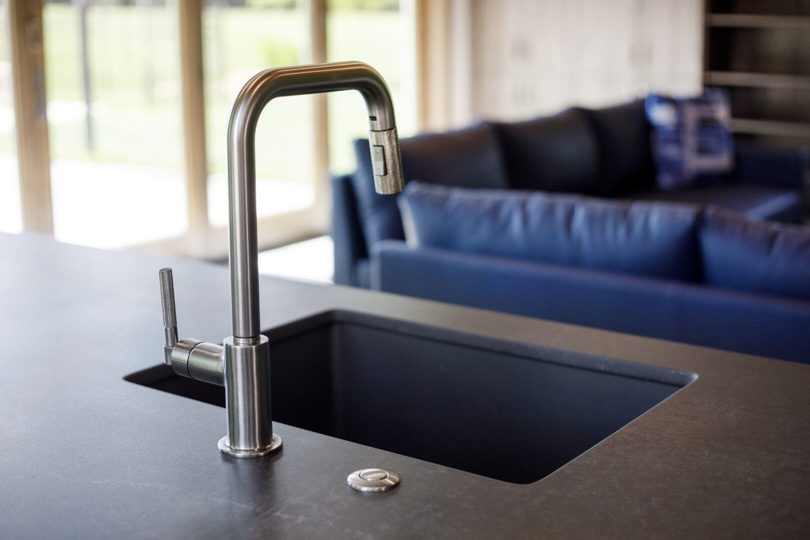 Modern kitchen sink with sleek faucet in a stylish, contemporary home interior.
