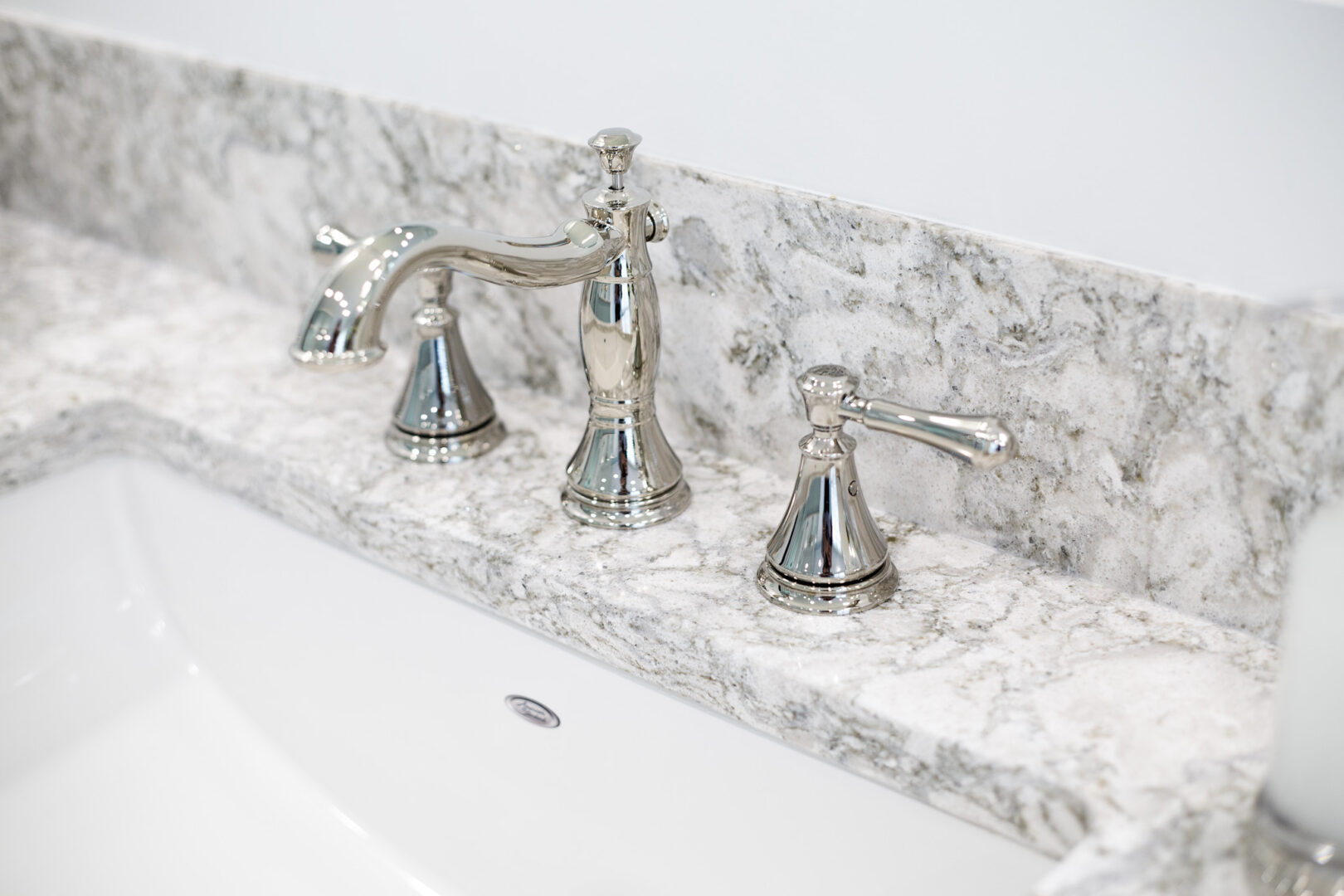 Elegant bathroom faucet with marble countertop in Wichita, Kansas.