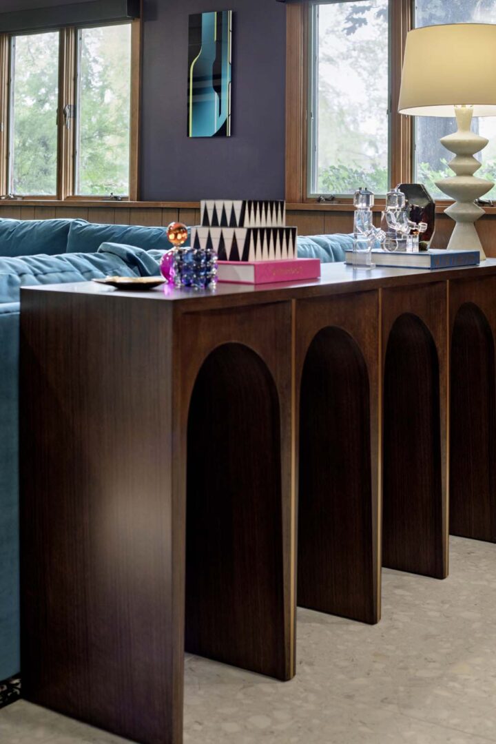 Elegant wooden sideboard with curved arches in a stylish living room setting.