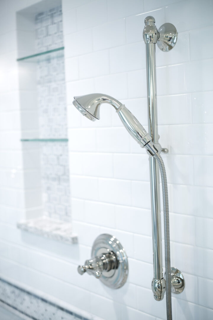 Stylish chrome showerhead and adjustable hand shower in a contemporary bathroom.