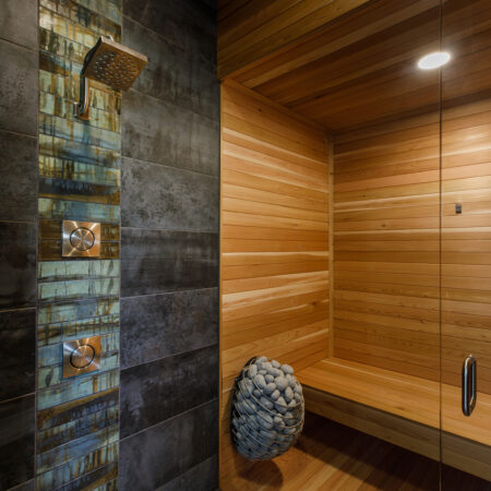 Contemporary steam shower featuring wood paneling and textured tile walls in a spa-like setting.