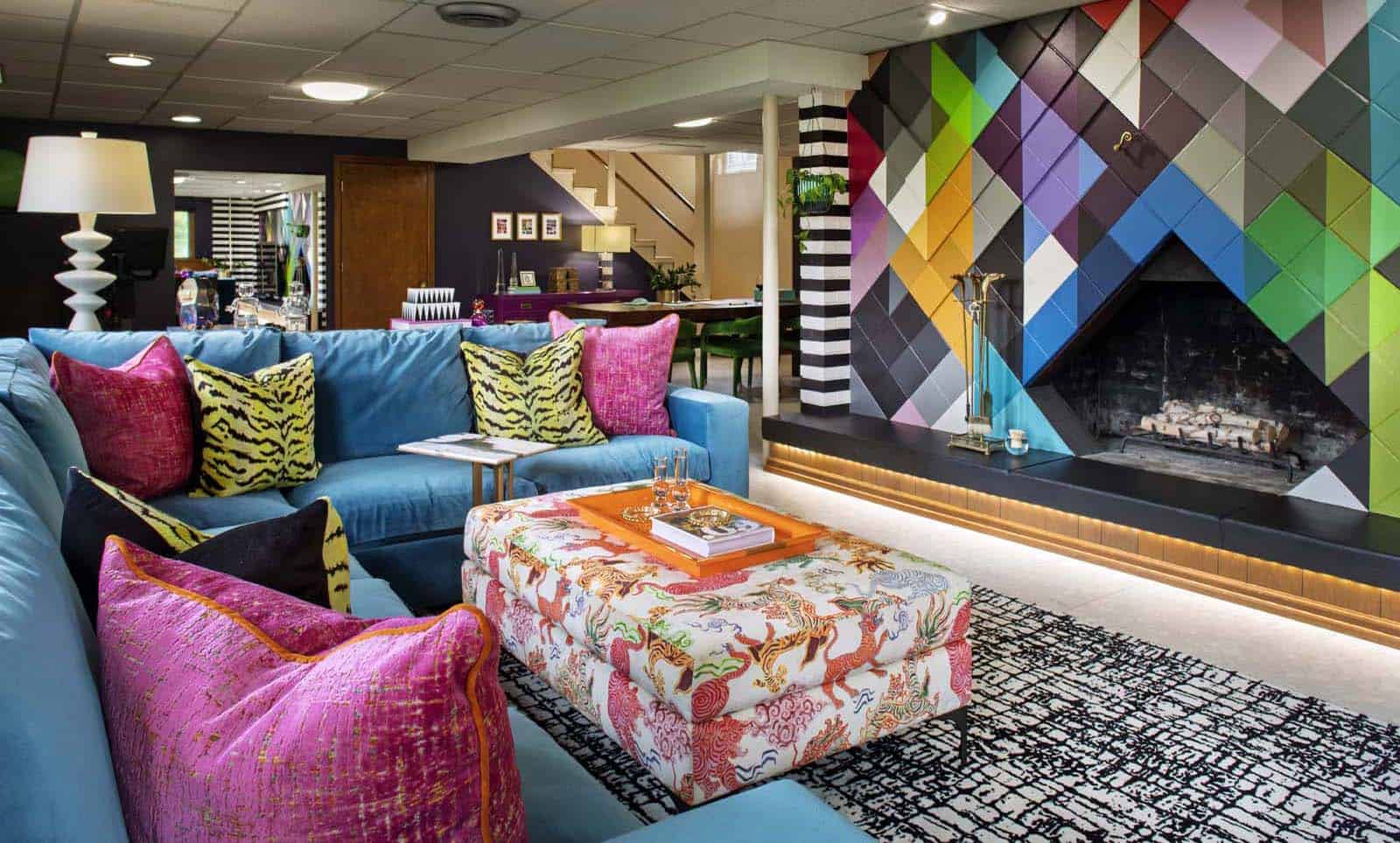 Colorful modern living room with vibrant furniture and geometric wall art.