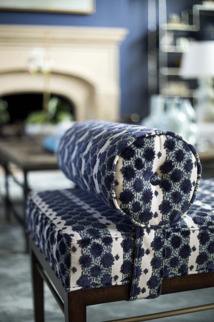 Upholstered bench with navy and white floral pattern in a stylish interior.