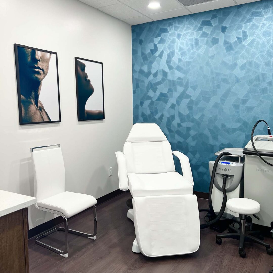 Modern medical treatment room with white chair and blue accent wall.