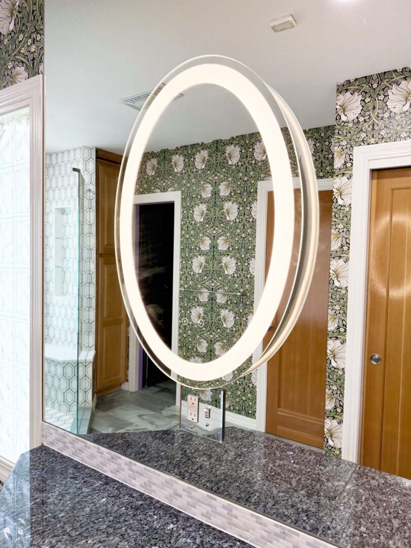 Oval illuminated bathroom mirror with LED lighting.