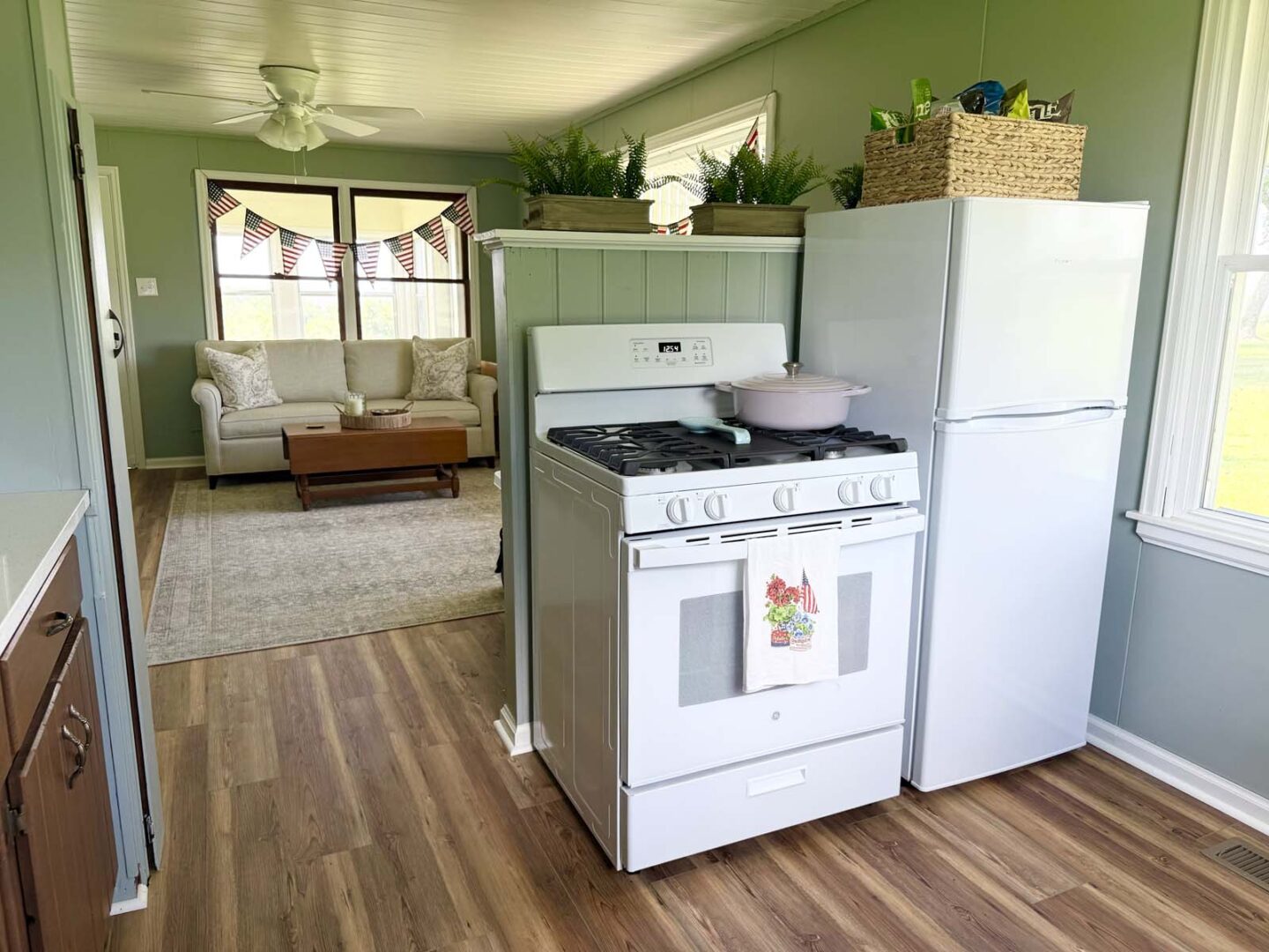 Interior kitchen with vintage stove and modern refrigerator in a cozy home.